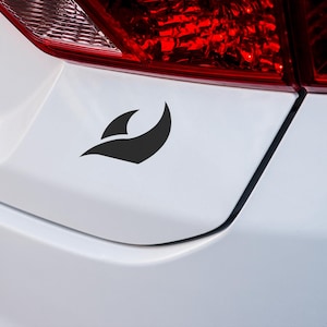 May include: A black and white abstract wave design sticker on a white car.
