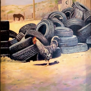 May include: A rooster stands in front of a pile of old tires. The tires are stacked in a haphazard way, and some are leaning against a wooden building. The rooster is facing the camera, and its head is turned to the side. The rooster is a light gray color with a red comb and wattles. The background is a blurry landscape with a wooden outhouse in the distance.