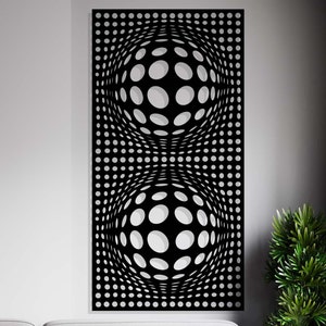 Könnte beinhalten: Schwarze Wanddekoration aus Metall mit einem geometrischen Design aus zwei sich überlappenden Kreisen, die aus kleineren Kreisen bestehen.