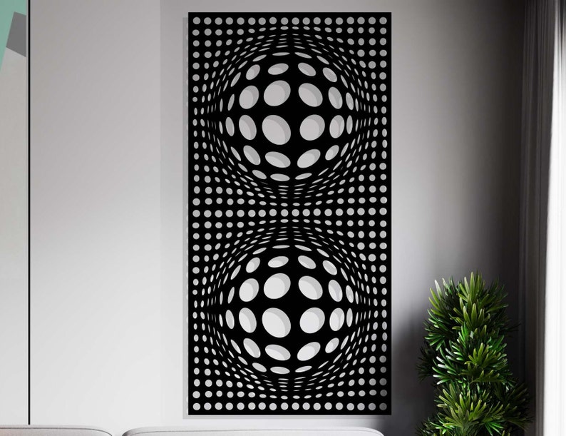 May include: Black metal wall decor with a geometric design of two overlapping circles made of smaller circles.