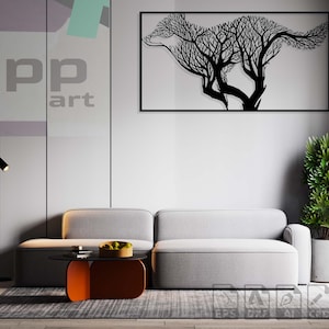 Könnte beinhalten: Ein schwarzes Wandbild aus Metall, das eine Wolfs-Silhouette aus Ästen darstellt. Die Kunst hängt an einer weißen Wand in einem Wohnzimmer mit einem grauen Sofa, einem Couchtisch und einer Topfpflanze.