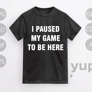 May include: Black t-shirt with white text that reads "I paused my game to be here".