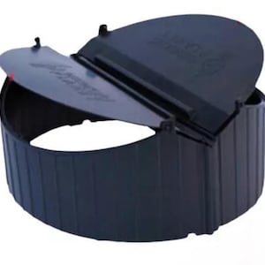 May include: A dark blue, cylindrical plastic container with a hinged lid. The lid is partially open, revealing the interior. The container has vertical ridges and appears to be designed for outdoor use.