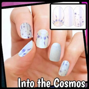 May include: A set of nail wraps with a space theme. The wraps feature a variety of designs, including stars, galaxies, and planets. The text "Into the Cosmos" is displayed at the bottom of the image.