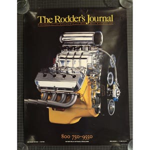 May include: Poster for "The Rodder's Journal" featuring a detailed image of a chrome and yellow engine. The engine has multiple components, including exhaust pipes and a belt. The poster includes the magazine's name and a phone number.