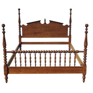 May include: A wooden bed frame with a headboard and footboard. The bed frame has a spindle design and is finished in a dark brown color.