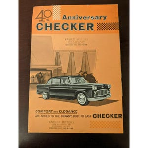 May include: An orange vintage advertisement for Checker cars. The ad features a black car with white-walled tires, and the text "40th Anniversary CHECKER." The ad also includes the text "COMFORT and ELEGANCE ARE ADDED TO THE BRAWNY, BUILT TO LAST CHECKER."
