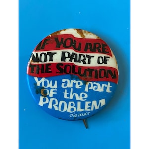 May include: A blue and red button with the text "If you are not part of the solution you are part of the problem" and the word "cleaver" at the bottom.
