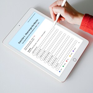 A white tablet displays a Korean language exercise titled 'Rearrange the Blocks.' The exercise involves rearranging blocks of words to form sentences, with instructions and an example provided. A hand holding a white stylus hovers over the tablet's screen, ready to interact with the digital worksheet. Color-coded labels for 'who,' 'what,' 'do,' and 'where' are at the bottom.