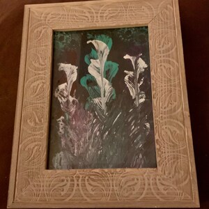 May include: A framed painting of abstract flowers in shades of white, teal, and purple on a black background.