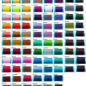 May include: A collection of 100 spools of thread in various colors, each spool is labeled with a number. The spools are arranged in rows and columns on a white background.