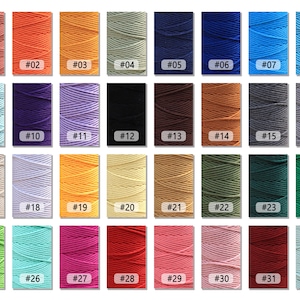 May include: A collection of 32 spools of cotton cord in various colors, including red, blue, green, yellow, and purple. Each spool is labeled with a number from 01 to 32.