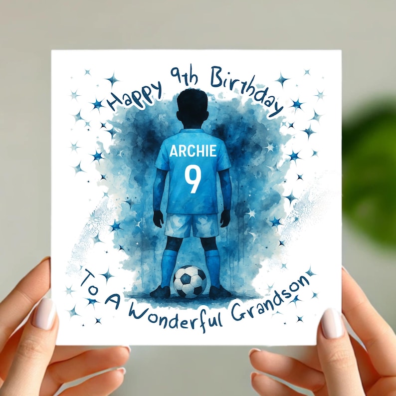 May include: A square birthday card with a watercolor illustration of a boy in a blue soccer uniform, number 9, and the name "Archie". The card reads "Happy 9th Birthday To A Wonderful Grandson" with blue star accents.