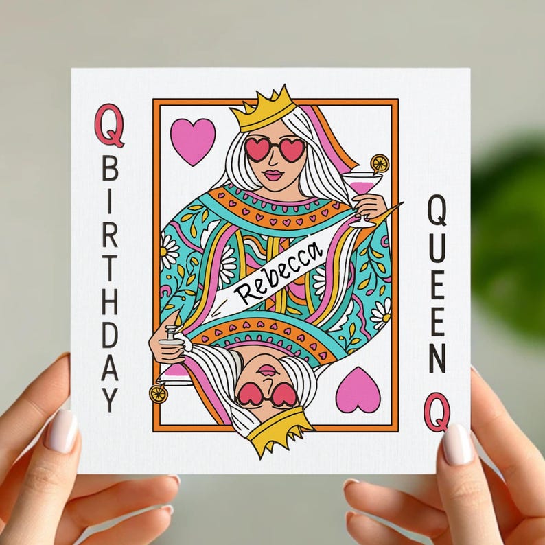 May include: A birthday card featuring a queen of hearts playing card design with a woman wearing sunglasses and a crown. The card says "Queen" and "Birthday" on the side and "Rebecca" on a sash.