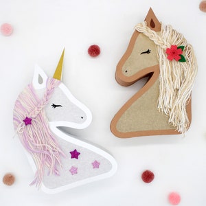 May include: Two paper mache animal head decorations. A white unicorn with a pink and purple yarn mane and a brown horse with a white yarn mane. Both have glitter stars and flowers.