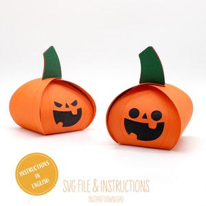 May include: Two orange pumpkin-shaped boxes with black jack-o'-lantern faces. The boxes have green stems and are ready to be assembled. SVG file and instructions are included.