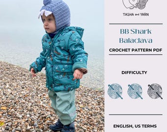 Puede incluir: Un patrón de crochet para una balaclava de tiburón para bebé, con un nivel de dificultad de tres ovillos de lana. El patrón está escrito en inglés usando términos estadounidenses y es para una sola talla.