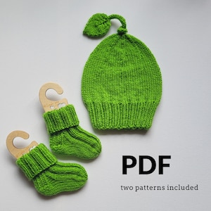 May include: A bright green knitted hat with a leaf-shaped topper and a pair of matching green knitted socks, each displayed on a wooden hanger. The image includes the text PDF and two patterns included, indicating a digital knitting pattern set.