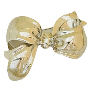 Vintage MONET silver shiny bow designer runway brooch image 1