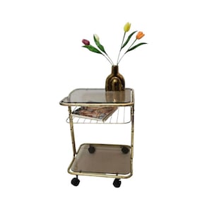 Vintage Mid Century Modern brass trolley bar table with smoky glass.