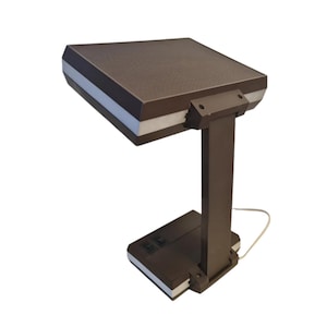 May include: A brown desk lamp with a rectangular shade and a flexible arm. The lamp has a white switch on the base.