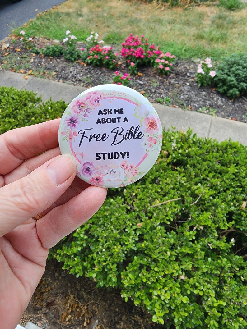 May include: A white button with pink flowers and the text "Ask me about a Free Bible Study!"