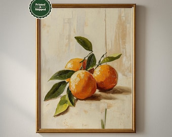 May include: A framed still life painting of oranges with green leaves. The oranges are a vibrant orange color, and the leaves are a deep green. The painting is in a gold frame. The text "Printed & Shipped" is in a green circle.