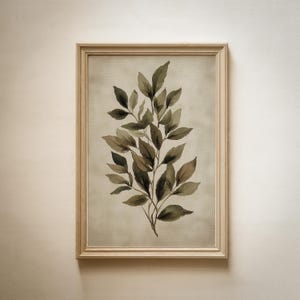 May include: A framed watercolor print featuring a botanical illustration of a leafy branch. The leaves are rendered in shades of green and brown against a neutral background. The frame is made of light-colored wood, adding a natural touch to the artwork.