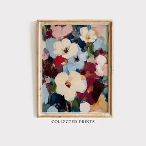 May include: A framed floral art print featuring a bouquet of white, pink, red, and blue flowers. The painting has visible brushstrokes and is set against a dark background. The frame is a light, natural wood color. The text "COLLECTED PRINTS" is at the bottom.