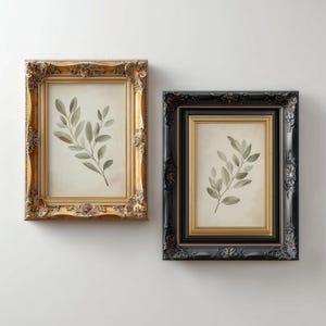 May include: Two framed botanical prints. One frame is gold with ornate detailing, the other is black. Each print features a watercolour-style depiction of a leafy branch in shades of green and grey against a cream background.