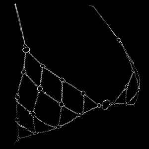 May include: A silver chain body jewelry piece with multiple interconnected rings. The chain is made of small, delicate links.