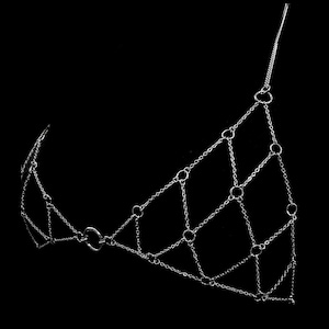 May include: A silver chain body jewelry piece with a geometric design. The chain is made of small, interconnected rings.