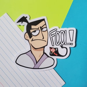 May include: A cartoon illustration of a man with black hair, a white shirt, and a serious expression. He is saying "FOOL!" with a red and black creature behind him.