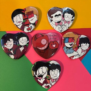 May include: A collection of heart-shaped buttons featuring cartoon characters in various poses. The buttons showcase characters with different expressions and outfits, with some designs including the text "Love you darling."
