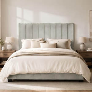May include: A light sage green upholstered bed frame featuring a tall, rectangular headboard with vertical channel tufting. The bed is dressed in a crisp white duvet cover, two large white pillows, and two smaller rectangular accent pillows.