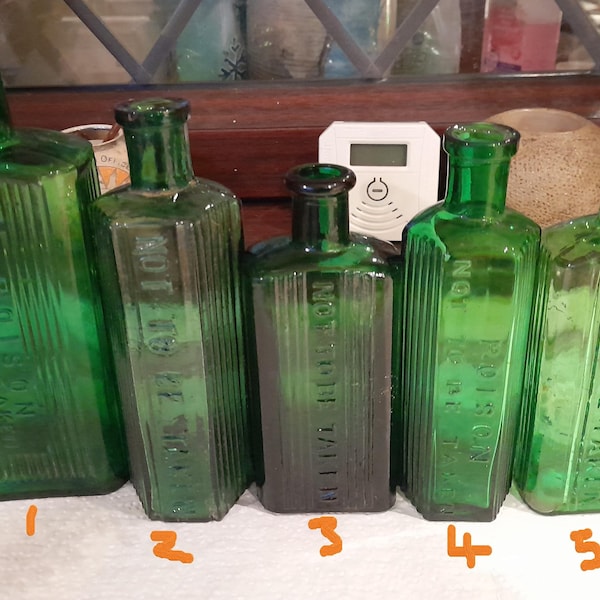 Ewardian green ribbed poison bottles diffrent writing and shapes