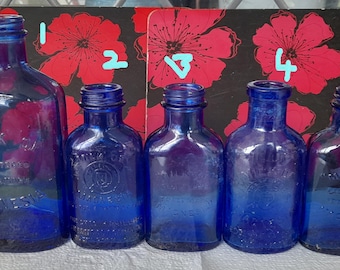 vintage blue cure bottles with embossed writing milk of magnesia