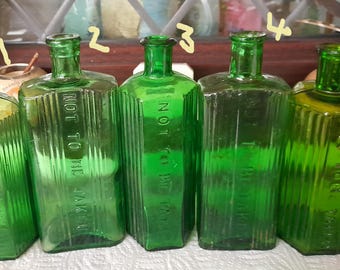 Ewardian large green ribbed poison bottles diffrent writing and shapes