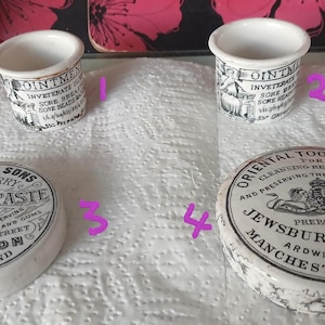 May include: Two white ceramic ointment pots with black text and two white ceramic tooth paste lids with black text. The lids feature the text S. Maw, Son & Sons White Cherry Tooth Paste and Oriental Tooth Paste by Jewsbury & Brown, Manchester.