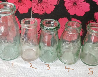 Lot of small edwardian milk bottles diffrent writing.