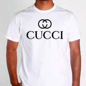 May include: White t-shirt with a black interlocking 'C' logo and the word "CUCCI" printed on the front.