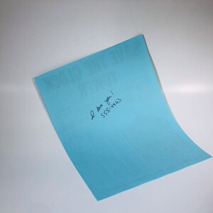 May include: A light blue card with the text "You Got This" printed on it. The card has handwritten text that says "I love you! 555-1823"