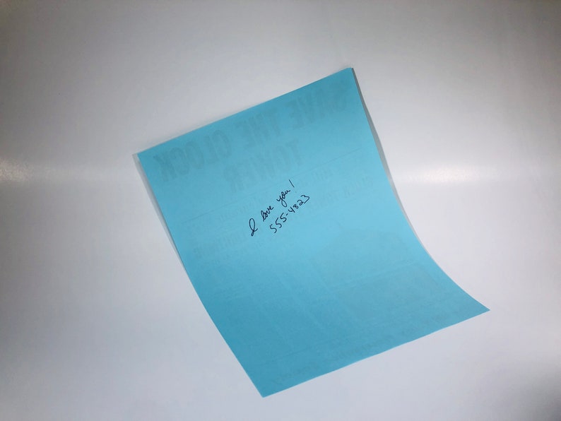 May include: A light blue card with the text "You Got This" printed on it. The card has handwritten text that says "I love you! 555-1823"