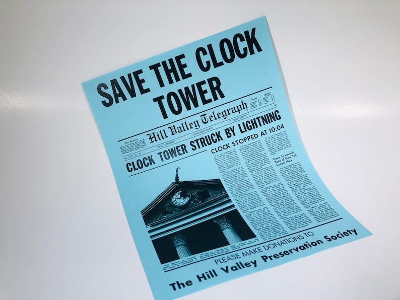May include: A blue poster with the text "SAVE THE CLOCK TOWER" in black. The poster features a black and white image of a clock tower with the text "Hill Valley Telegraph" and "CLOCK TOWER STRUCK BY LIGHTNING" in black. The text "CLOCK STOPPED AT 10:04" is also in black. The poster also includes the text "PLEASE MAKE DONATIONS TO The Hill Valley Preservation Society" in black.