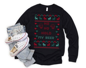 May include: Black long-sleeve shirt with a Christmas-themed design featuring reindeer, snowflakes, and the text "Ho Ho Hold My Beer".