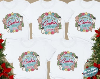 May include: Five white t-shirts with a Christmas cookie design. Each shirt has the text "Member of the Cookie Crew" with a different name below it. The names are: Caddie, Grandma, Brad, Mommy, and Daddy.