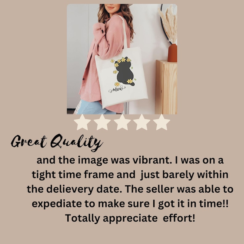 May include: A white tote bag with a black cat silhouette and yellow flowers. The cat is wearing a flower crown and the text "Meow" is printed below the cat. The bag is being held by a person wearing a pink shirt.