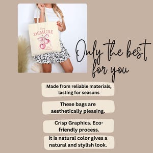 May include: A beige tote bag with a pink and white design featuring the text "Very Demure" and a pair of cherries. The bag is made from reliable materials and is aesthetically pleasing.
