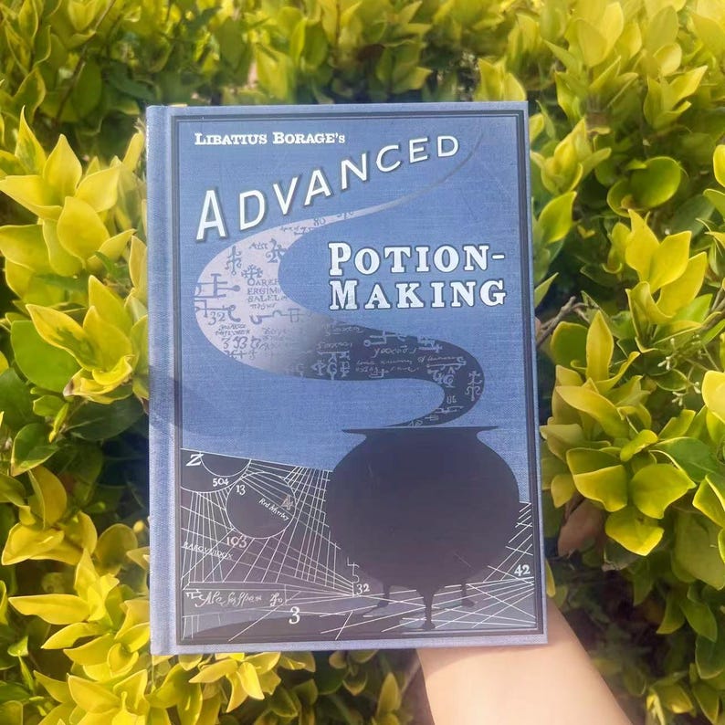 May include: A book titled "Advanced Potion-Making" by Libatius Borage. The cover is blue with white text and a black cauldron illustration. The background features a complex diagram and smoke-like design.