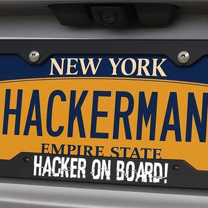 May include: A New York license plate with the name "HACKERMAN" in bold letters. The plate is yellow with blue accents and a black frame. The text "HACKER ON BOARD!" is at the bottom.